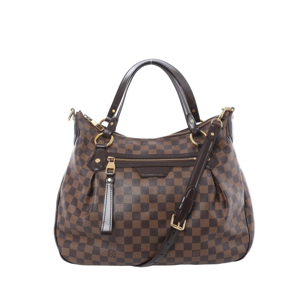 Louis Vuitton Ivorie MM shoulder bag in brown Damier Ebene canvas with dark leather top handles, detachable strap, gold-tone hardware, and front zip pocket on white background.
