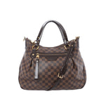Louis Vuitton Ivorie MM shoulder bag in brown Damier Ebene canvas with dark leather top handles, detachable strap, gold-tone hardware, and front zip pocket on white background.