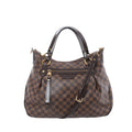 Louis Vuitton Ivorie MM shoulder bag in brown Damier Ebene canvas with dark leather top handles, detachable strap, gold-tone hardware, and front zip pocket on white background.