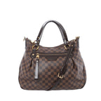 Louis Vuitton Ivorie MM shoulder bag in brown Damier Ebene canvas with dark leather top handles, detachable strap, gold-tone hardware, and front zip pocket on white background.