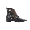 Louis Vuitton ankle boot in black leather with brown Monogram canvas overlay, silver buckles, and side zipper on white background