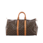 Louis Vuitton Keepall 45 brown Monogram canvas travel bag with tan leather top handles and straps, zip closure, front view on white background
