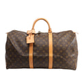 Louis Vuitton Monogram Canvas Keepall 50 Travel Bag M41426 featuring brown LV monogram canvas, tan leather handles and trim, gold-tone hardware, zip closure, and attached leather name tag, displayed on a white background.
