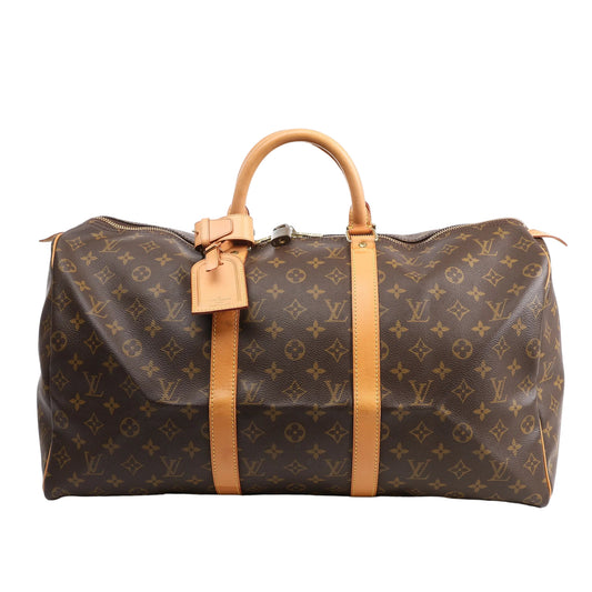Louis Vuitton Monogram Canvas Keepall 50 Travel Bag M41426 featuring brown LV monogram canvas, tan leather handles and trim, gold-tone hardware, zip closure, and attached leather name tag, displayed on a white background.