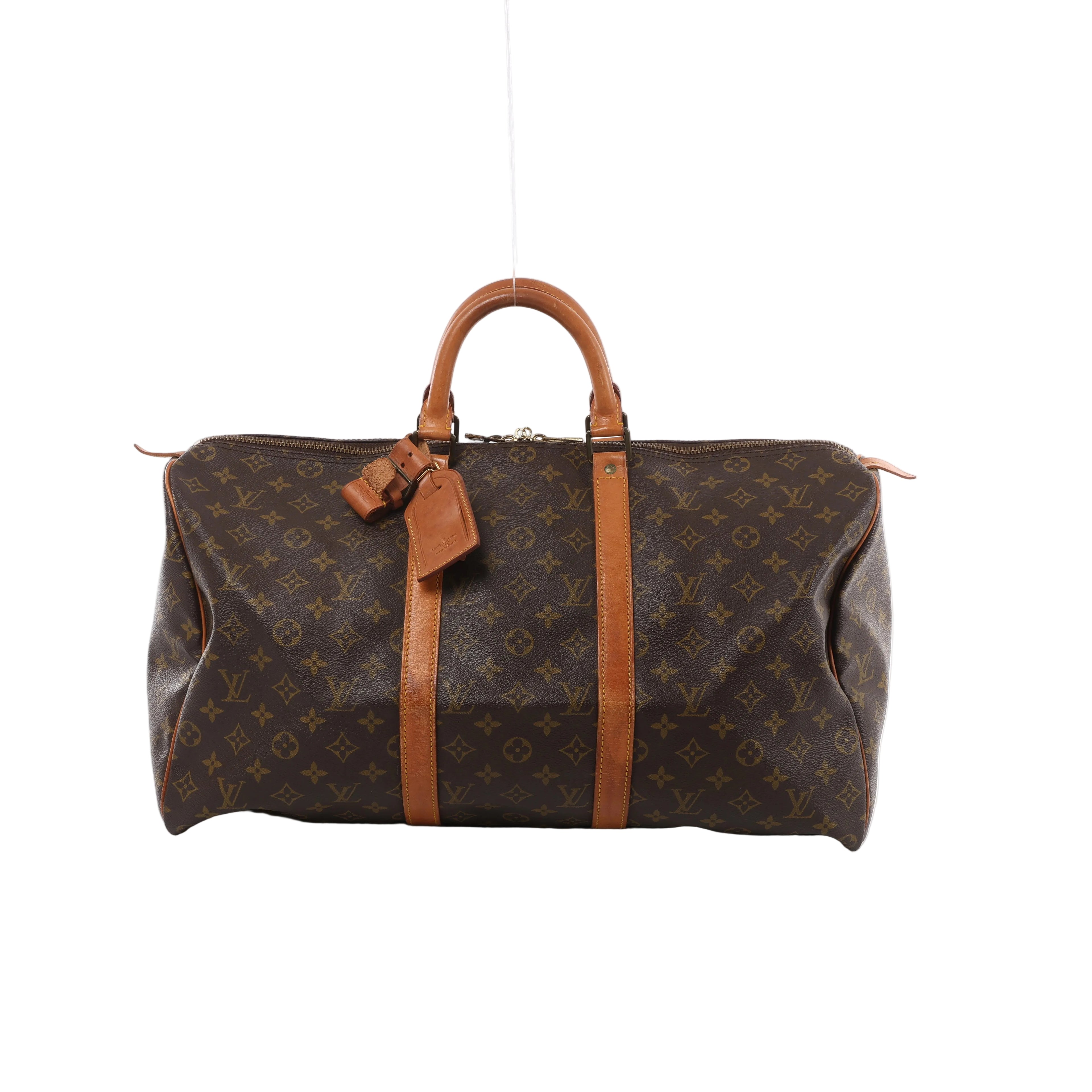 Brown Louis Vuitton Keepall 50 Monogram canvas travel bag with tan leather top handles, vertical trim, luggage tag and gold-tone zip hardware.