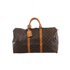 Brown Louis Vuitton Keepall 50 Monogram canvas travel bag with tan leather top handles, vertical trim, luggage tag and gold-tone zip hardware.
