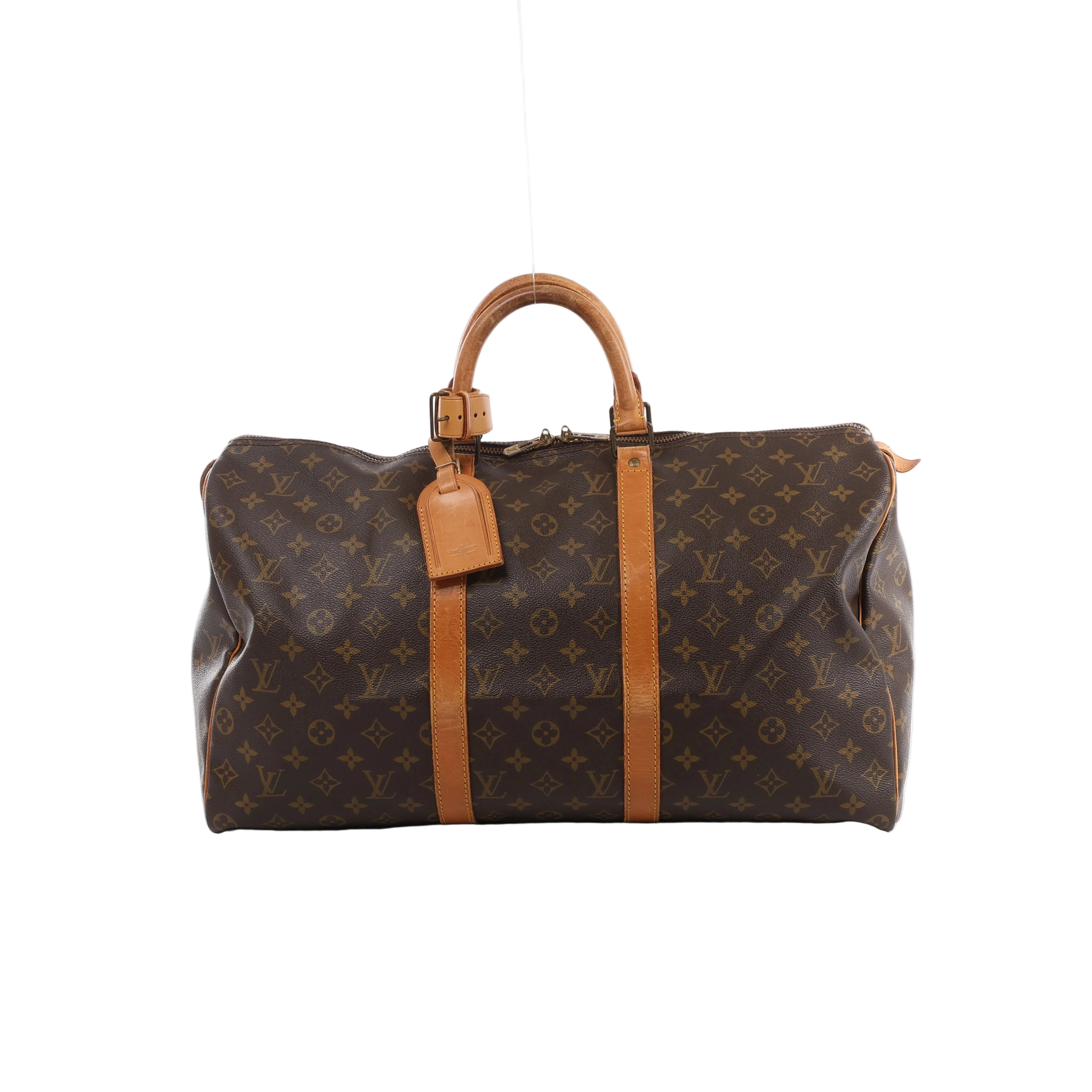 Brown Louis Vuitton Keepall 50 Monogram canvas travel bag with tan leather top handles, vertical trim, luggage tag and gold-tone zip hardware.