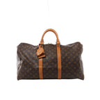 Louis Vuitton Keepall 50 Monogram canvas travel bag with tan leather top handles, vertical trim, luggage tag and gold-tone zip hardware.