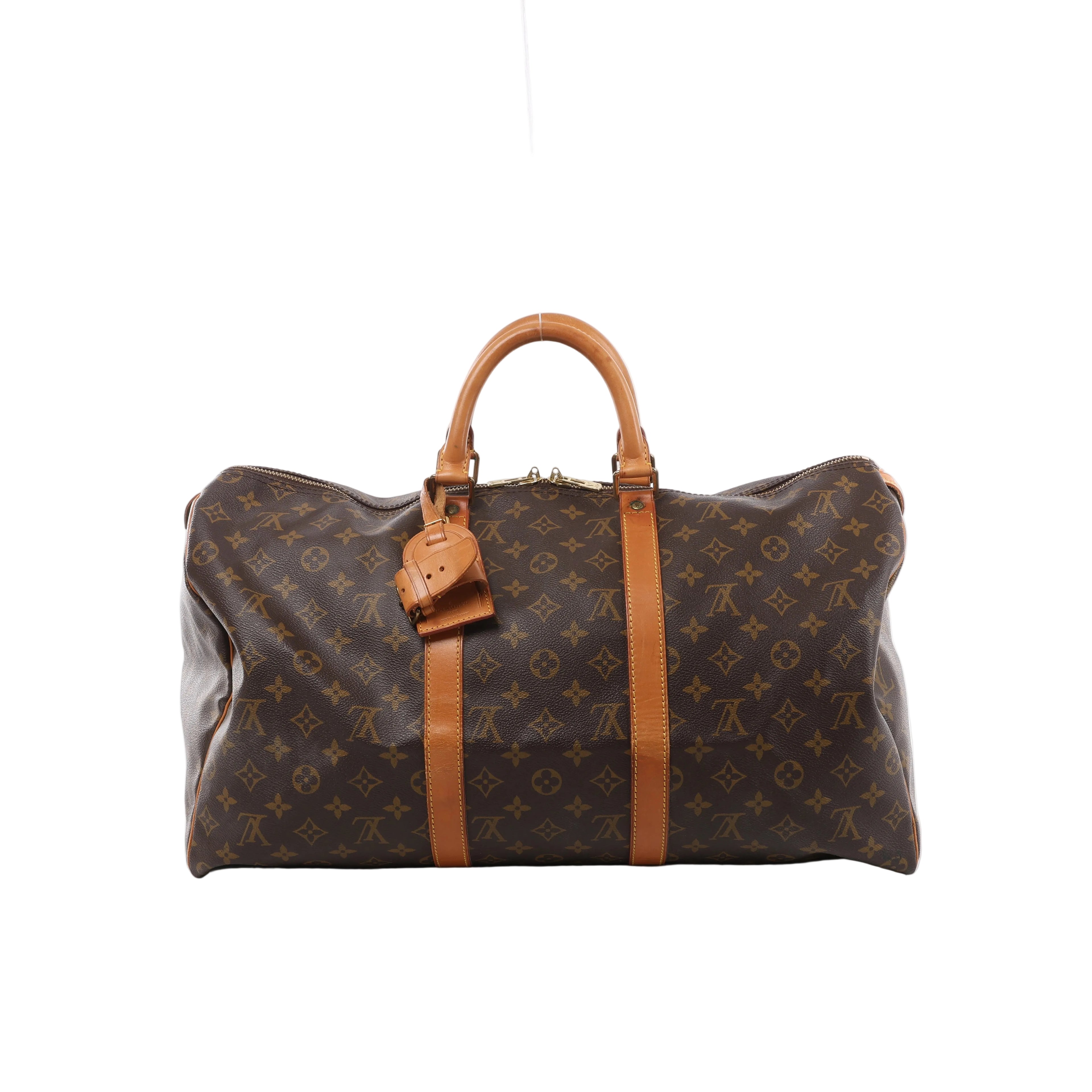 Louis Vuitton Keepall 50 Monogram canvas travel bag with tan leather top handles, vertical trim, luggage tag and gold-tone zip hardware.