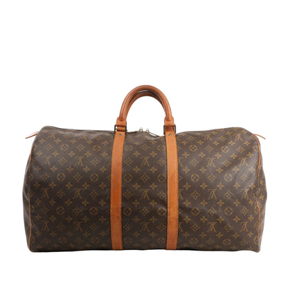 Louis Vuitton Keepall 55 travel bag in brown Monogram canvas with natural leather handles and trim, featuring gold-tone hardware.