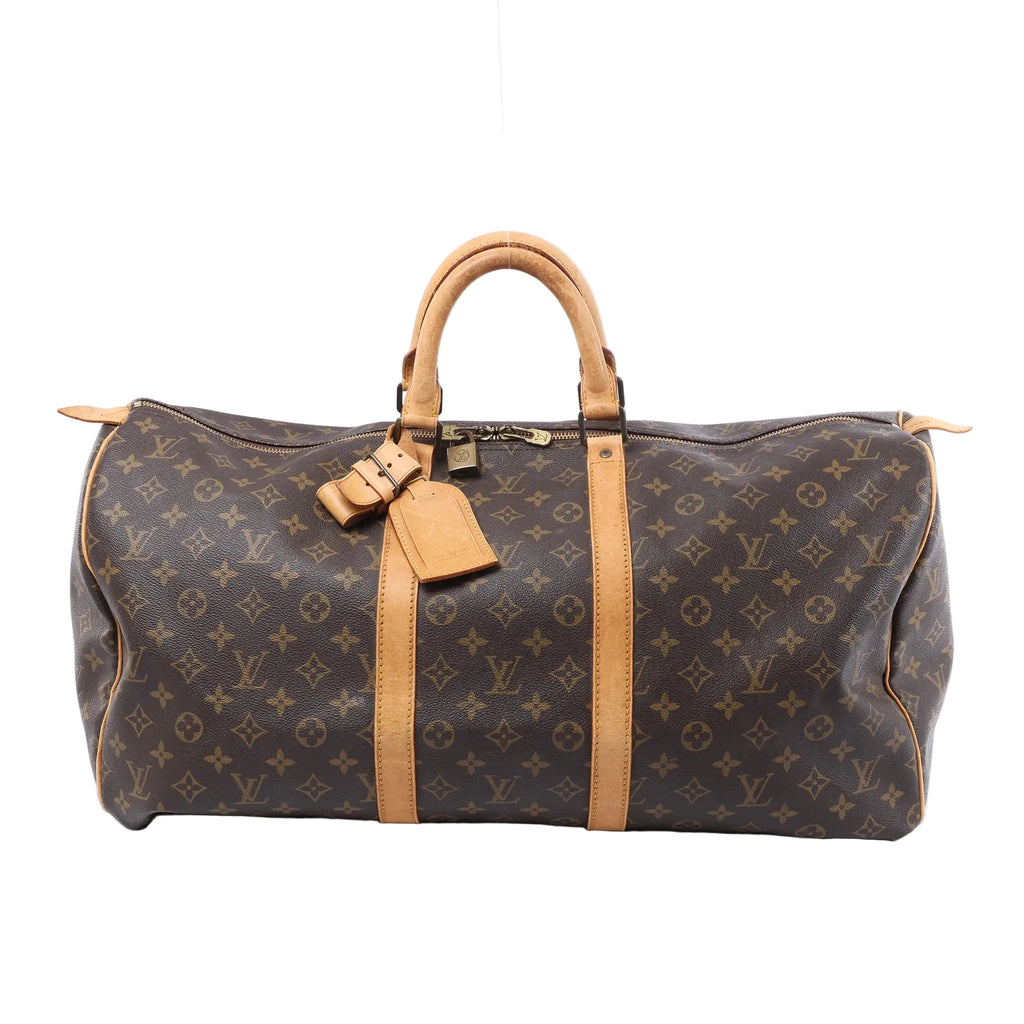 Front view of a brown Louis Vuitton Keepall 55 Monogram canvas travel bag with tan leather trim, rolled handles, luggage tag and padlock on a white background.