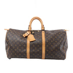Front view of a brown Louis Vuitton Keepall 55 Monogram canvas travel bag with tan leather trim, rolled handles, luggage tag and padlock on a white background.