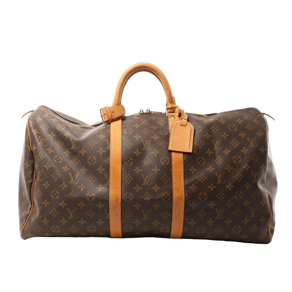Louis Vuitton Keepall 55 travel bag in brown Monogram canvas with vachetta leather trim, zip-top closure, rolled top handles, and leather name tag on white background.