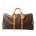 Louis Vuitton Keepall 55 travel bag in brown Monogram canvas with vachetta leather trim, zip-top closure, rolled top handles, and leather name tag on white background.