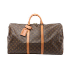 Louis Vuitton Keepall 55 brown Monogram canvas travel duffle with tan leather trim, double top handles, zip-top closure, and luggage tag, front view on white background.