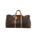 Brown Louis Vuitton Keepall 55 Monogram canvas travel bag with tan leather top handles, vertical trim, luggage tag and gold-tone zip hardware.