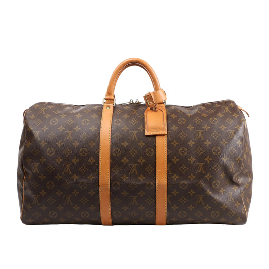Louis Vuitton Monogram Canvas Keepall 55 Travel Bag M41424 featuring brown LV monogram canvas, tan leather handles and trim, gold-tone hardware, zip closure, and attached leather name tag, displayed on a white background.