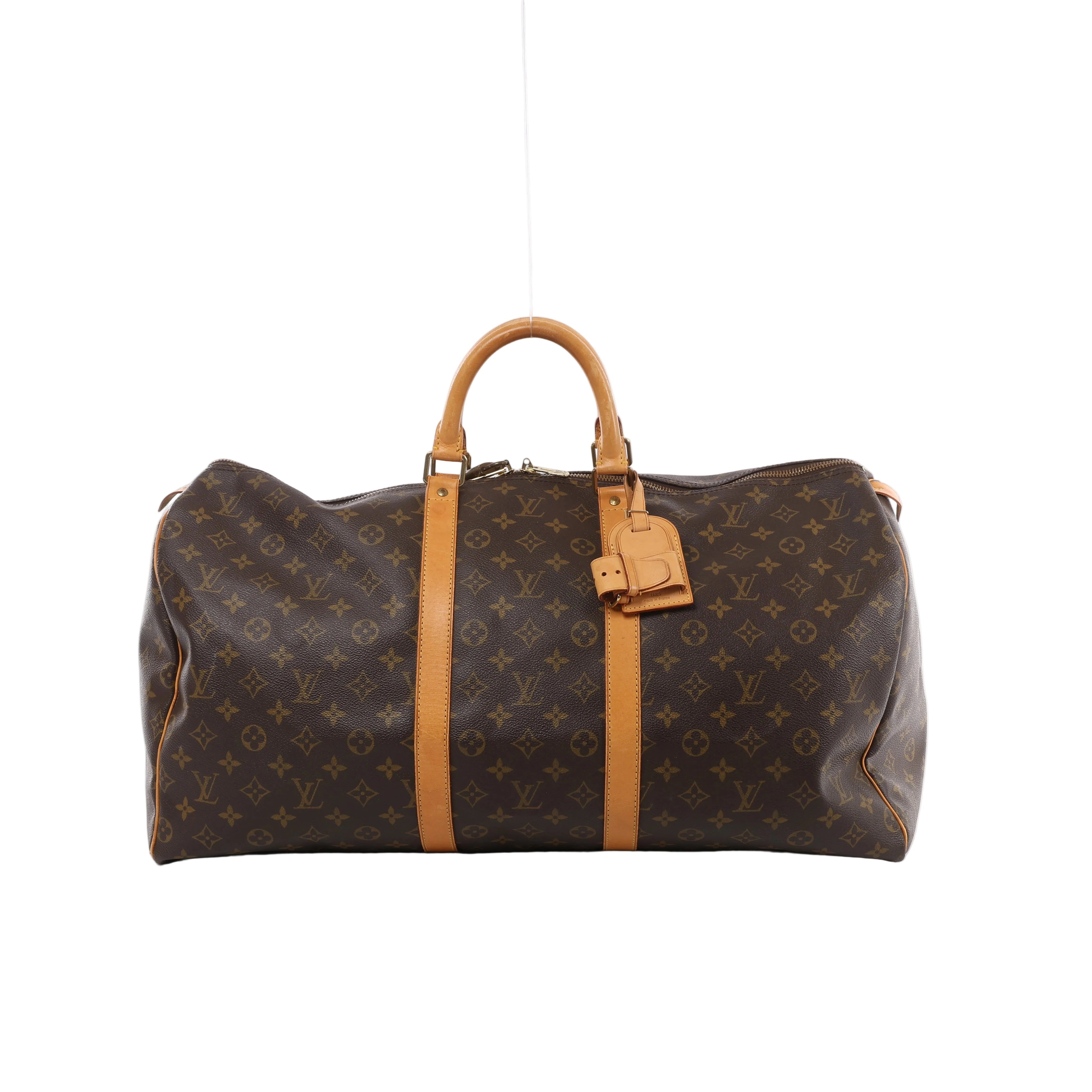 Brown Louis Vuitton Keepall 55 Monogram canvas travel bag with tan leather top handles, vertical trim, luggage tag and gold-tone zip hardware.