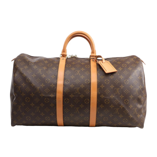 Louis Vuitton Monogram Canvas Keepall 55 Travel Bag M41424 featuring brown LV monogram canvas, tan leather handles and trim, gold-tone hardware, zip closure, and leather name tag, displayed on a white background.