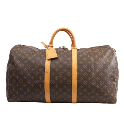 Louis Vuitton Monogram Canvas Keepall 55 Travel Bag M41424 featuring brown LV monogram canvas, tan leather handles and trim, gold-tone hardware, zip closure, and leather name tag, displayed on a white background.