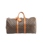 Louis Vuitton Keepall 55 brown Monogram canvas travel duffle with tan leather trim, double top handles, zip-top closure, and luggage tag, front view on white background.