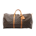 Louis Vuitton Keepall 60 brown Monogram canvas travel duffle with vachetta leather top handles, two vachetta leather bands, hanging leather tag, and top zip closure, shown on a white background.