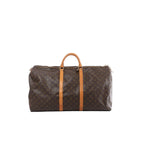 Louis Vuitton Keepall 60 brown Monogram canvas travel bag with tan leather top handles and trim, gold-tone zip closure, shown on white background