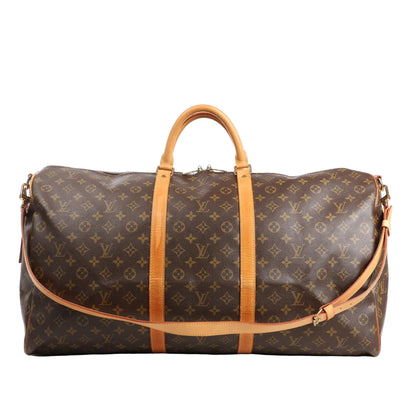 Louis Vuitton Keepall Bandoulière 60 travel bag in brown Monogram Canvas featuring natural Vachetta leather top handles and trim, detachable shoulder strap, gold-tone hardware, and a spacious cylindrical silhouette ideal for travel.