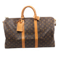 Louis Vuitton Keepall Bandoulière 45 Monogram canvas travel bag with tan leather top handles, vertical trim, luggage tag and gold-tone zip hardware.