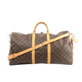 Louis Vuitton Keepall Bandoulière 55 brown Monogram canvas travel duffle with tan leather trim, top handles, detachable shoulder strap, zip-top closure, and luggage tag, front view on white background.