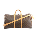 Louis Vuitton Keepall Bandoulière 55 brown Monogram canvas travel duffle with tan leather trim, top handles, detachable shoulder strap, zip-top closure, and luggage tag, front view on white background.