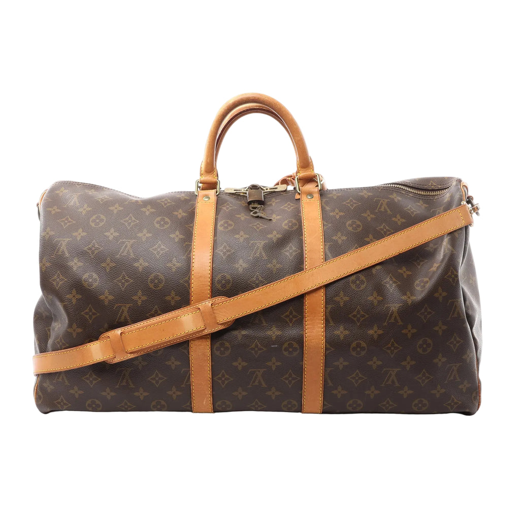 Louis Vuitton Keepall Bandoulière 55 brown Monogram canvas travel duffle with vachetta leather top handles, two vachetta leather bands, detachable shoulder strap, and top zip closure, shown on a white background.