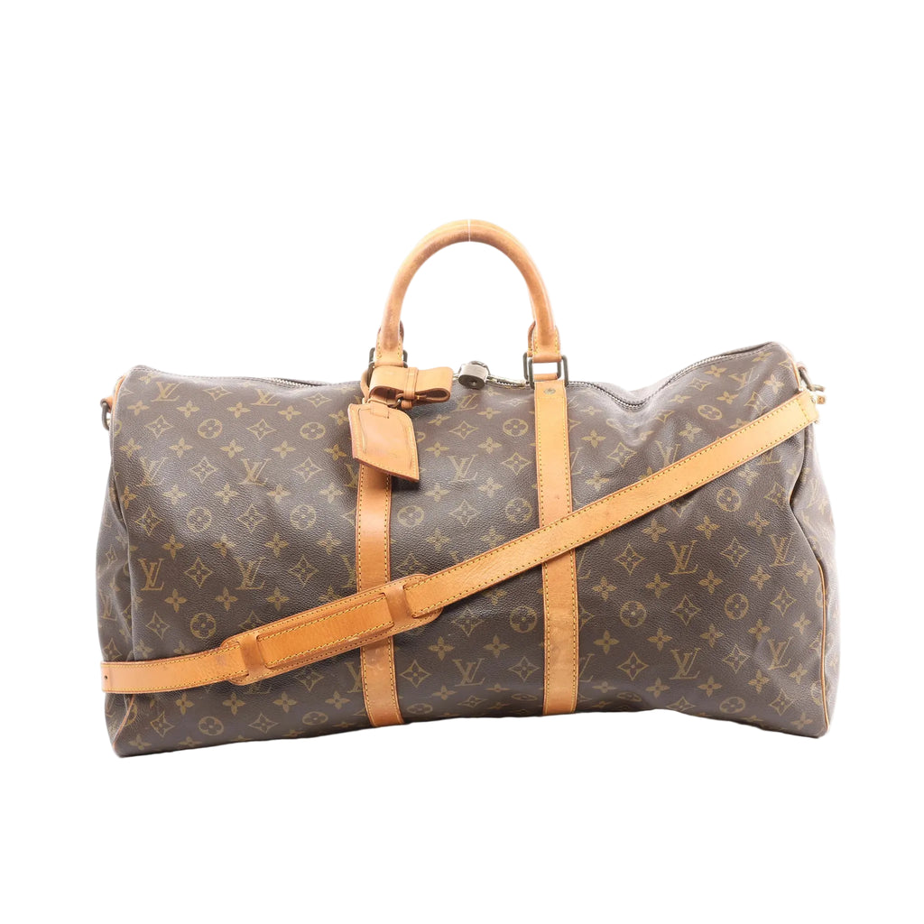 Louis Vuitton Keepall Bandoulière 55 brown monogram canvas travel bag with tan leather handles, trim, and detachable shoulder strap, front view on white background.