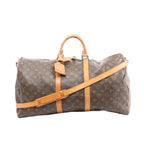 Louis Vuitton Keepall Bandoulière 55 brown monogram canvas travel bag with tan leather handles, trim, and detachable shoulder strap, front view on white background.
