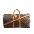 Louis Vuitton Keepall Bandoulière 55 duffle in brown Monogram canvas with tan leather trim, top handles, luggage tag, and shoulder strap, front view on white background.