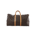 Louis Vuitton Monogram canvas Keepall 55 travel bag with tan leather handles and vertical leather straps on white background (shoulder strap not shown)