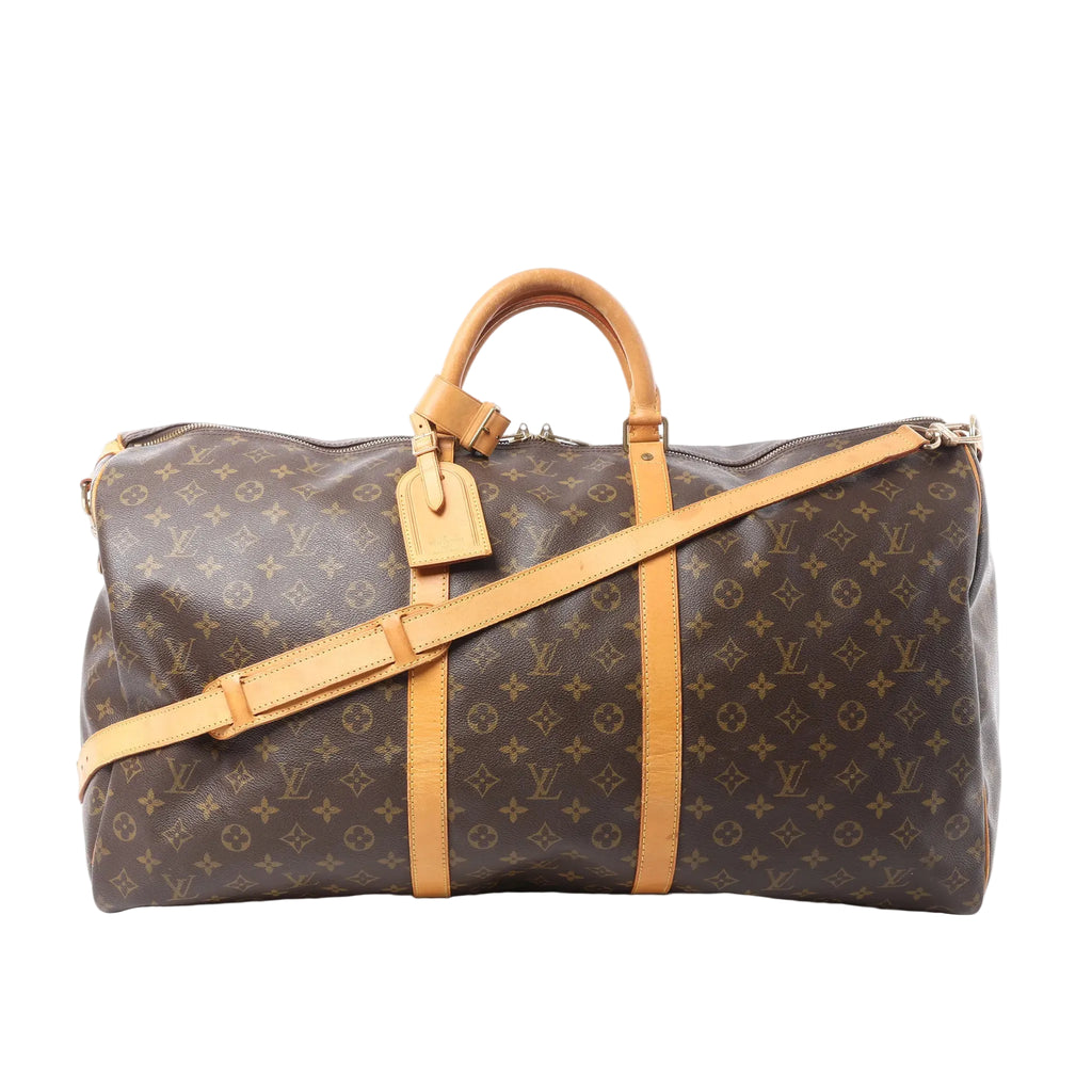 Louis Vuitton Monogram canvas Keepall Bandoulière 60 duffle bag with tan leather handles, luggage tag, and shoulder strap on white background