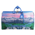 Louis Vuitton Keepall Bandoulière 50 M59676 travel bag in blue canvas featuring a colorful mountain and waterfall landscape print, blue leather trim, silver-tone hardware, and top handles with luggage tag and key bell.