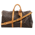 Louis Vuitton Keepall Bandoulière 50 in brown Monogram canvas with tan leather handles, shoulder strap, luggage tag and padlock.