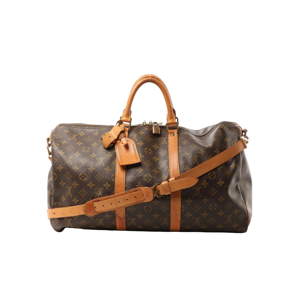 Louis Vuitton Monogram canvas Keepall Bandoulière 50 travel bag in brown with tan leather handles, shoulder strap, luggage tag, padlock, and top zip closure