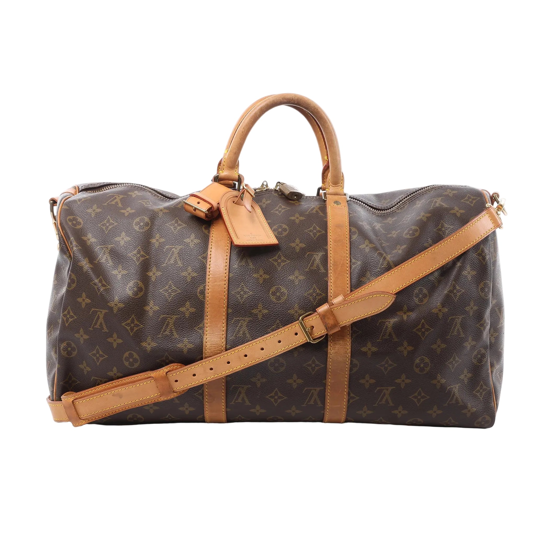 Front view of Louis Vuitton Monogram canvas Keepall Bandoulière 50 with tan leather trim, top handles, luggage tag and adjustable shoulder strap on a white background.