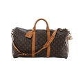 Louis Vuitton Keepall Bandoulière 50 Monogram canvas travel bag with vachetta leather trim, top handles, luggage tag, and detachable shoulder strap on white background.