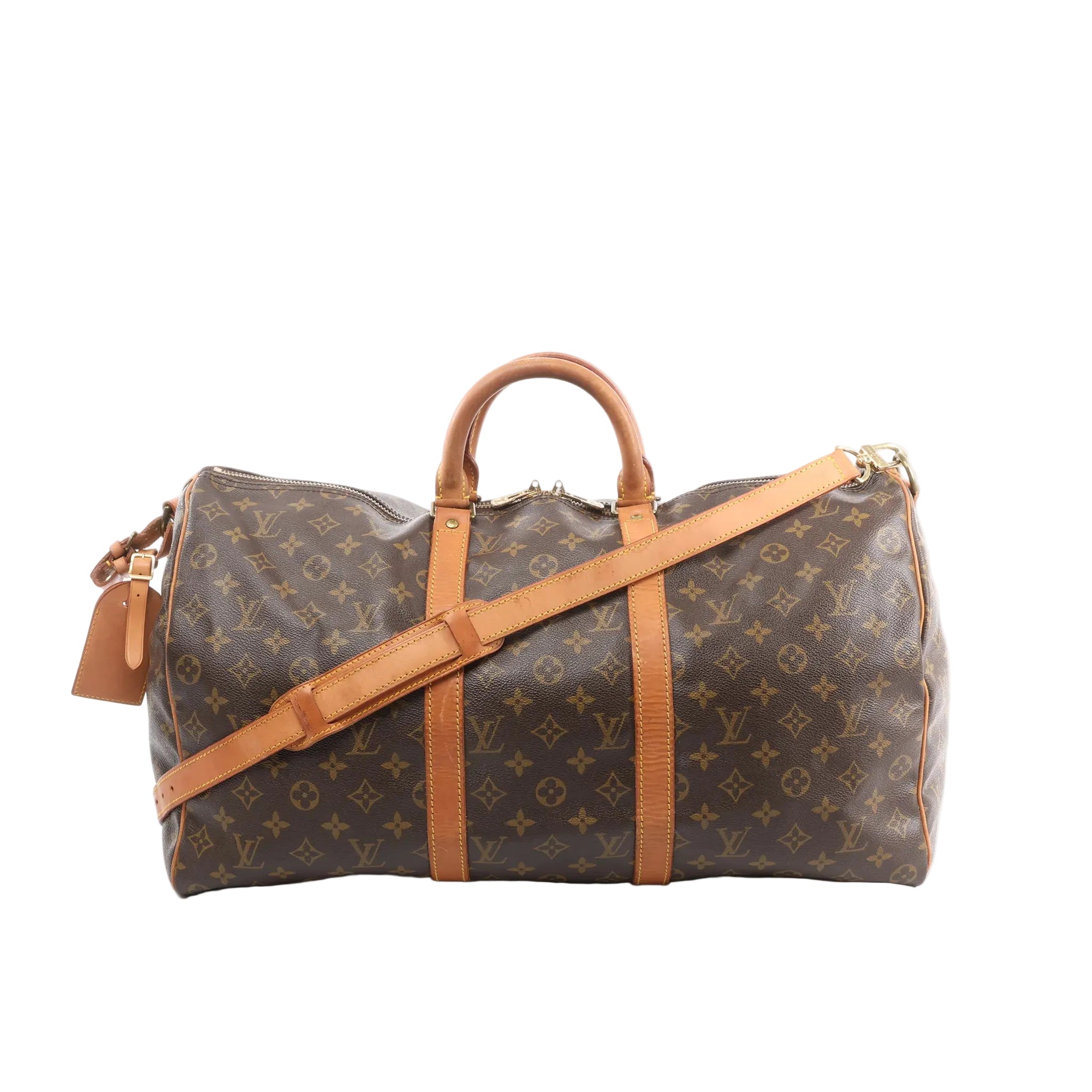 Louis Vuitton Monogram canvas Keepall Bandoulière 50 travel bag with tan leather trim, top handles, detachable shoulder strap, and hanging leather tag on a white background.