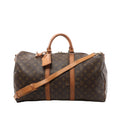Louis Vuitton Keepall Bandoulière 50 duffle bag in brown Monogram canvas with tan leather handles, luggage tag, and shoulder strap on white background