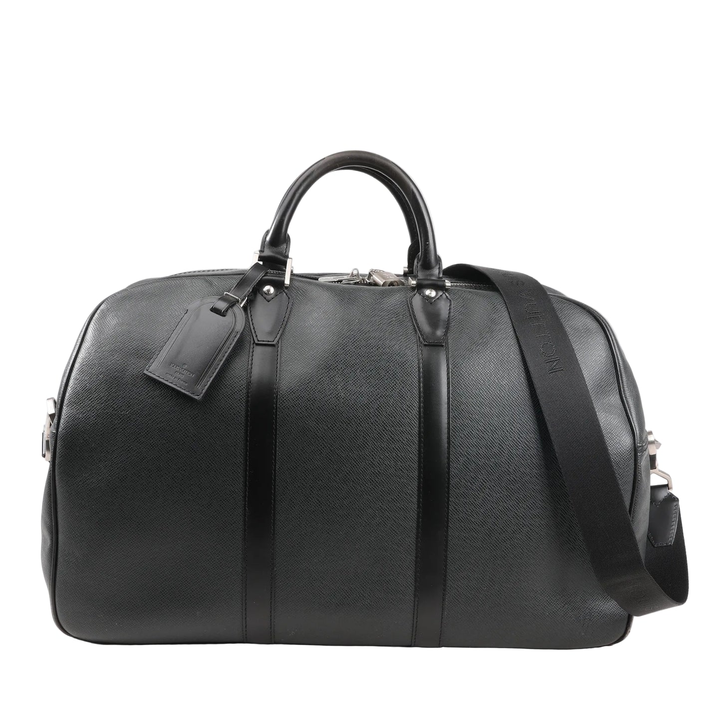 Front view of a Louis Vuitton Kendall PM M30122 travel bag in black Taiga leather featuring structured dual top handles, a detachable black shoulder strap, silver-tone hardware, and matching leather luggage tag.