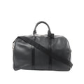 Black Louis Vuitton Kendall PM Taiga leather travel bag with double top handles, zip-top closure, and black shoulder strap.