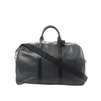 Black Louis Vuitton Kendall PM Taiga leather travel bag with double top handles, zip-top closure, and black shoulder strap.