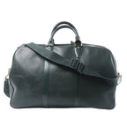 Louis Vuitton Kendall PM travel bag in dark green textured leather with rolled top handles, a wide detachable shoulder strap and gold-tone hardware.