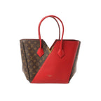 Louis Vuitton Kimono MM shoulder bag in brown Monogram canvas with red leather panels, gold-tone V detail, and red leather shoulder straps on white background.