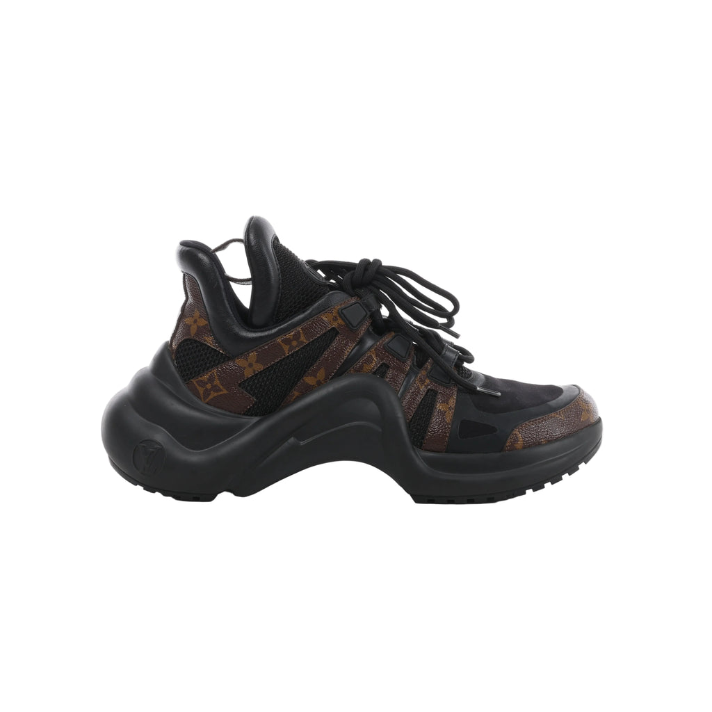 Side view of a Louis Vuitton LV Archlight sneaker with black mesh, brown Monogram panels, black laces and an oversized curved black sole.